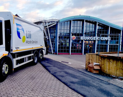 Liliwaste services truck providing waste collections parked outside Burger King.